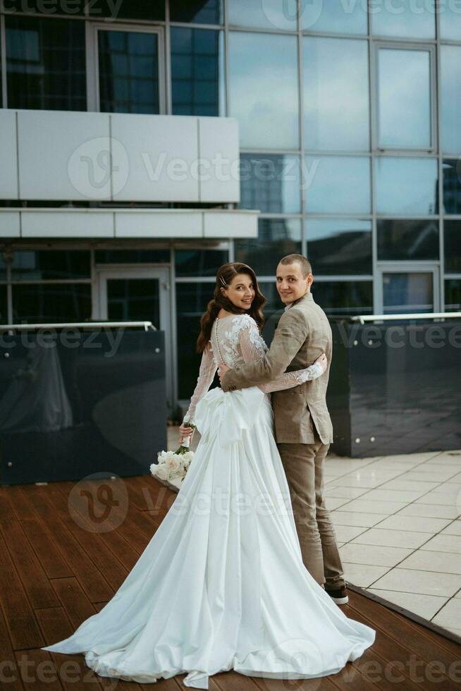 bride and groom first meeting on the roof of skyscraper photo