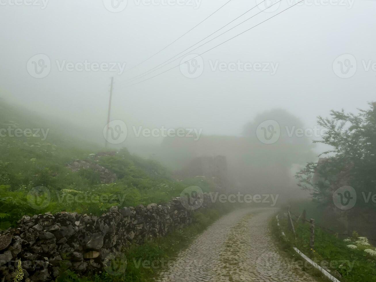 Dumanli Village in foggy weather, Gumushane, Turkiye. Santa Ruins. photo