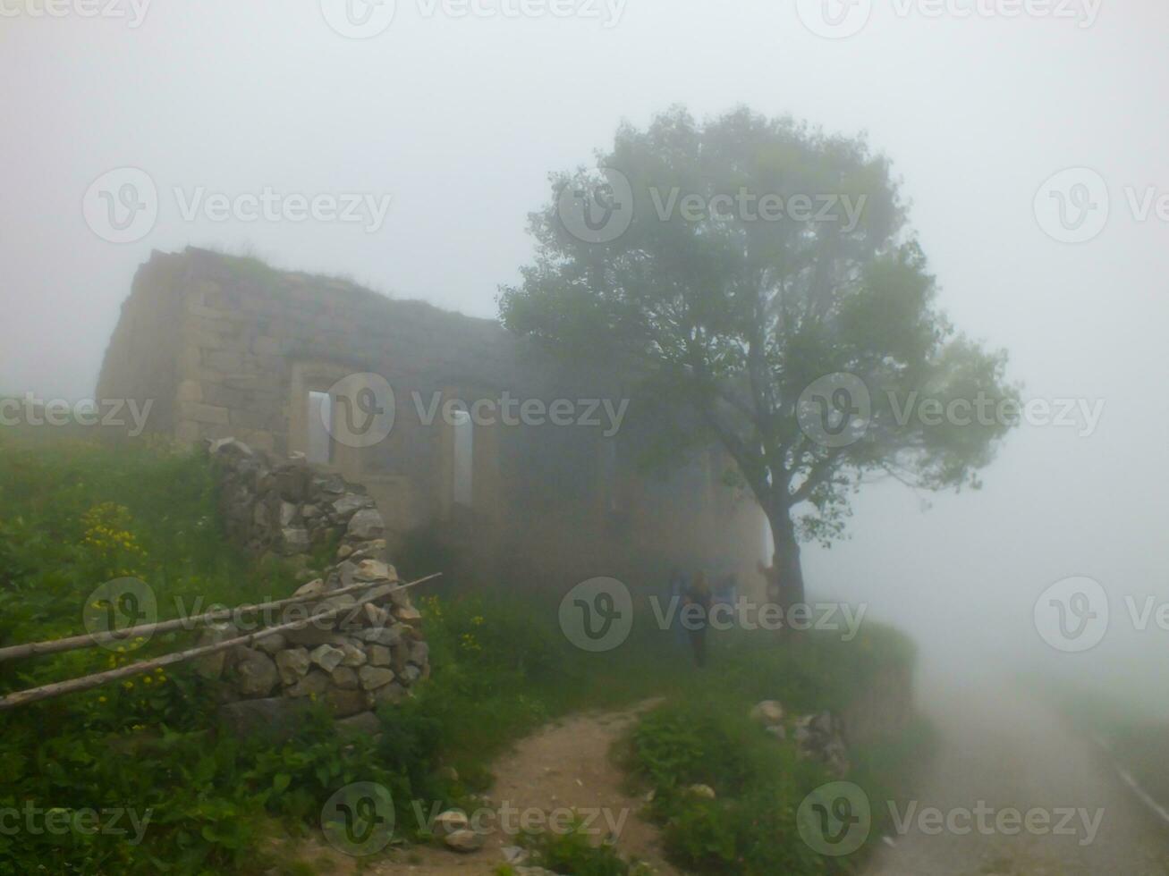 Santa Ruins in foggy weather, Gumushane, Turkey. Visitors looking at Santa Ruins Church. photo