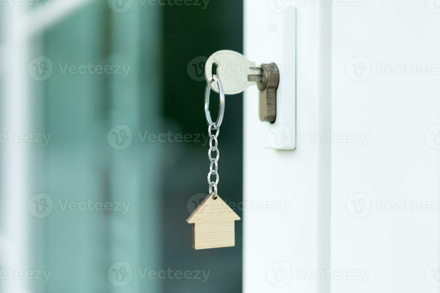 Landlord key for unlocking house is plugged into the door. Second hand house for rent and sale. Owner use hand unlock door mortgage for new home, buy, sell, renovate, investment, owner, estate photo