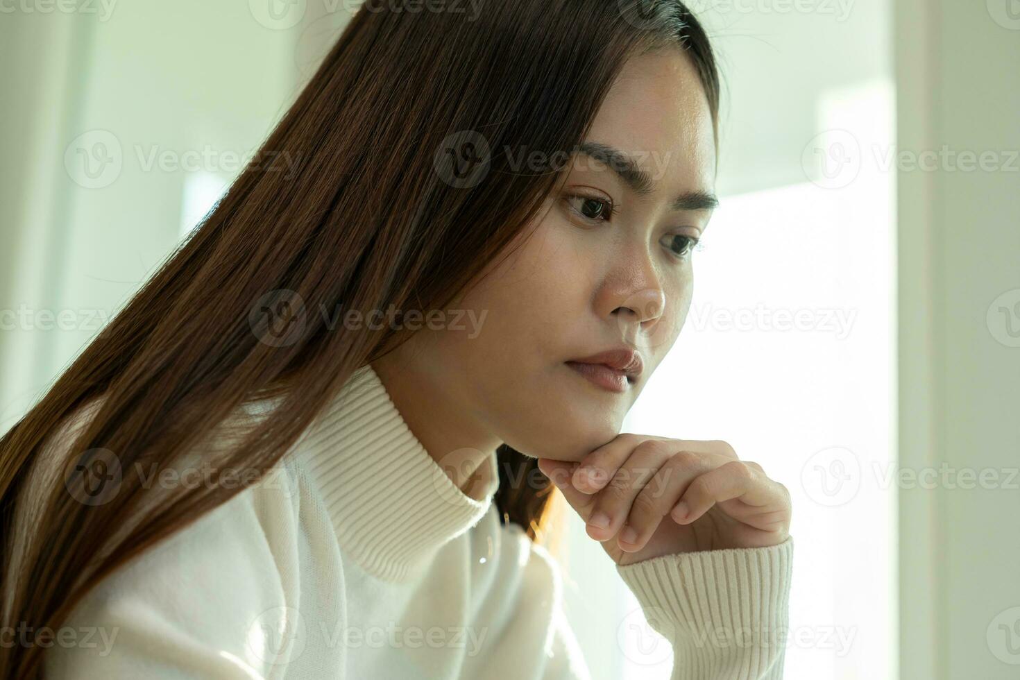 Depression and mental illness. Asian woman disappointed, sad after receiving bad news. Stressed girl confused with unhappy problems, arguing with boyfriend, cry and worry about unexpected pregnancy. photo