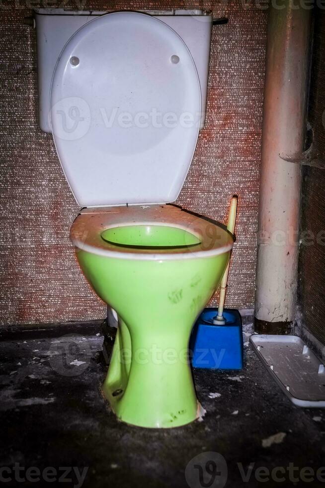 old dirty toilet in an abandoned house photo