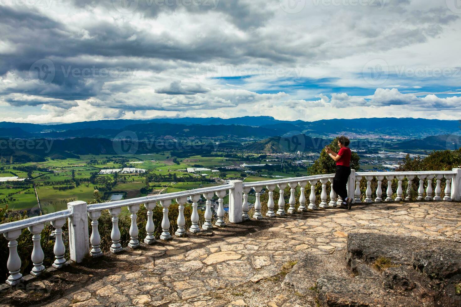 Young woman at a viewpoint over the beautiful Sopo valley at the department of Cundinamarca in Colombia photo