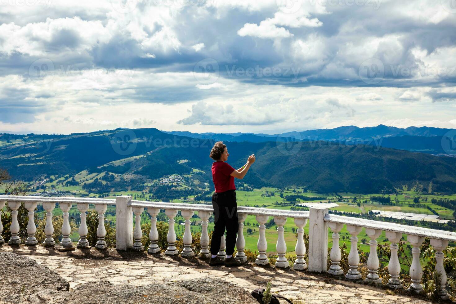 Young woman at a viewpoint over the beautiful Sopo valley at the department of Cundinamarca in Colombia photo