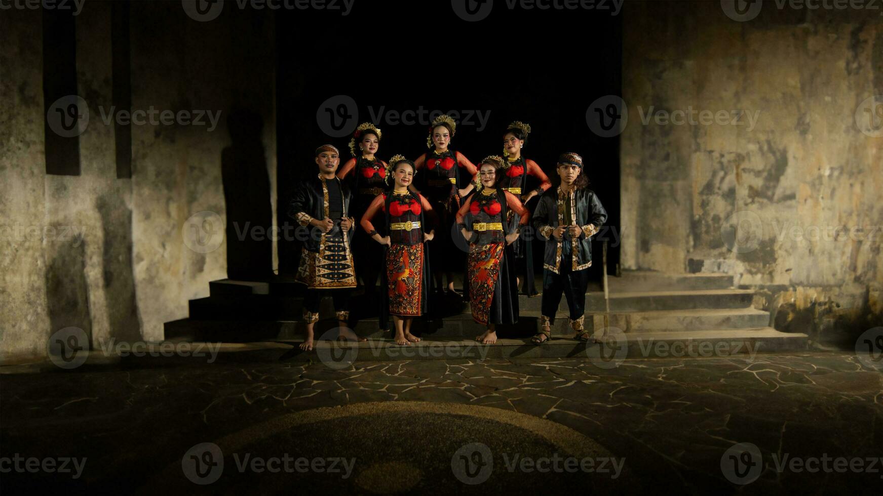 un grupo de bailarines estar alto como rojo disfraces proporcionar un dramático y agraciado contraste foto