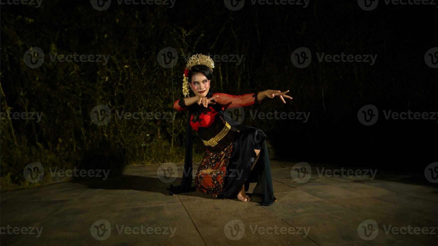 a Balinese dancer wearing a red dress with artistic details that add uniqueness to her appearance photo