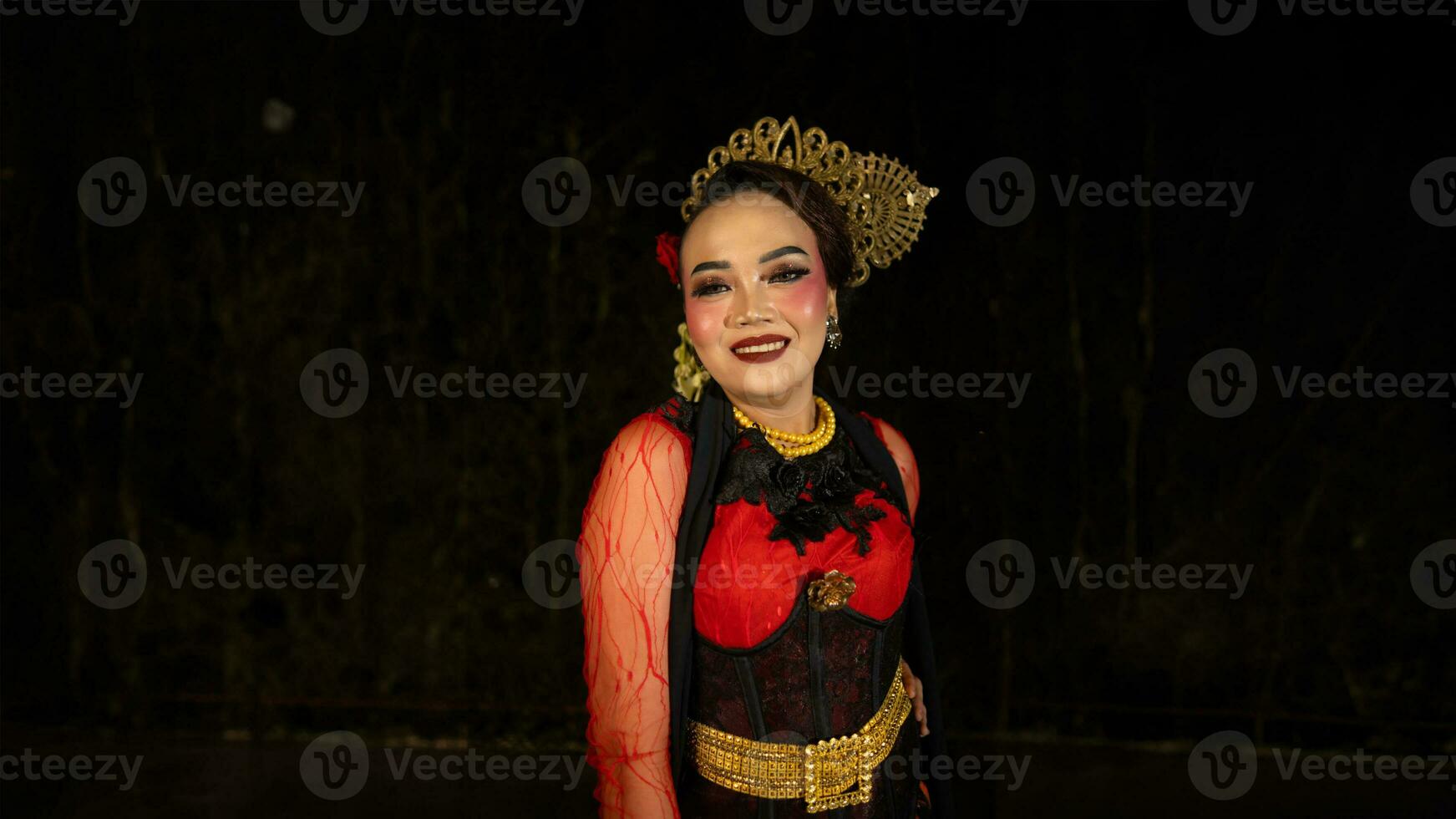 An Indonesian dancer becomes an ambassador of cultural beauty and elegance by dancing on stage photo