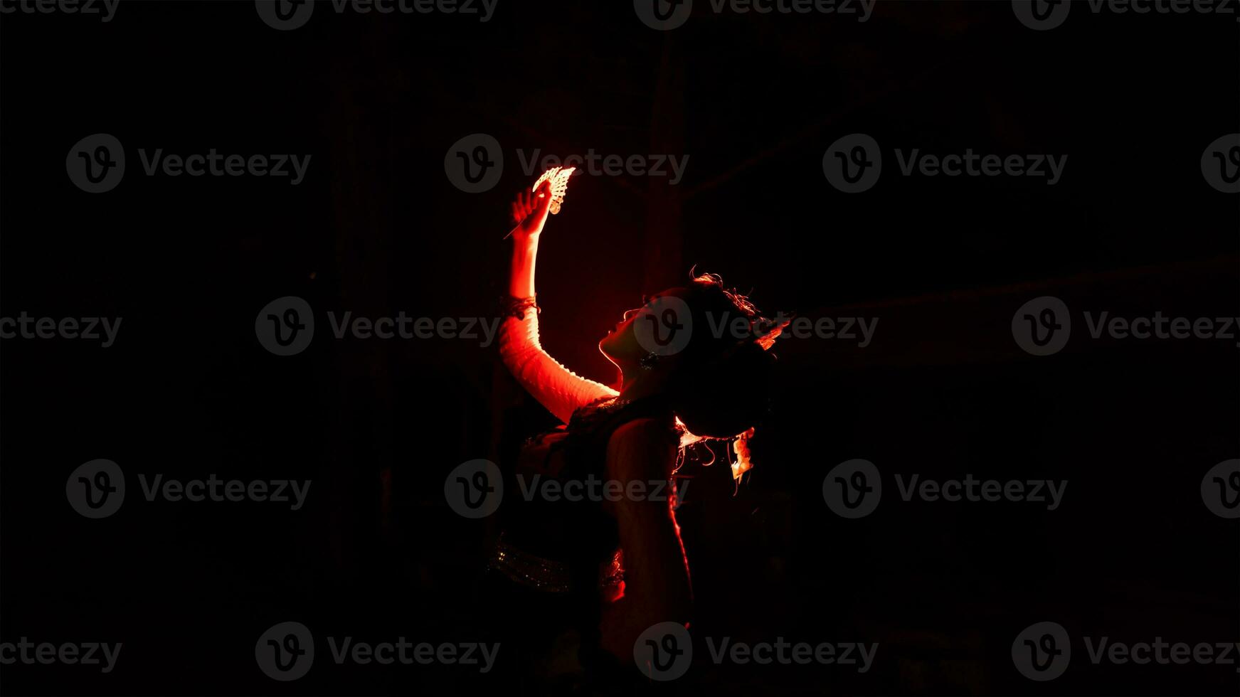 a woman holding gold jewelry with trembling hands and full of worries photo