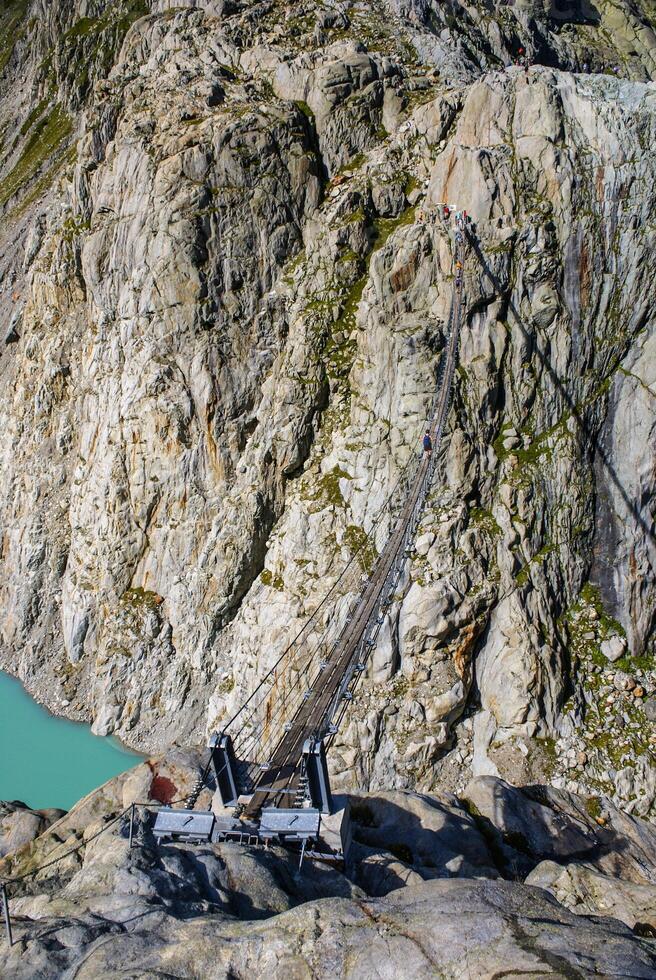 The bridge spans the lake, Triftsee, Switzerland photo