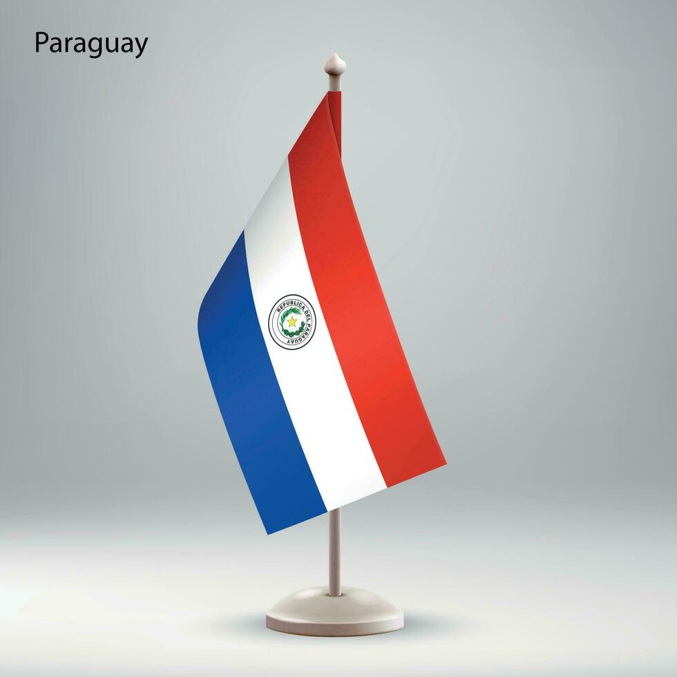 bandera de paraguay colgando en un bandera pararse. vector