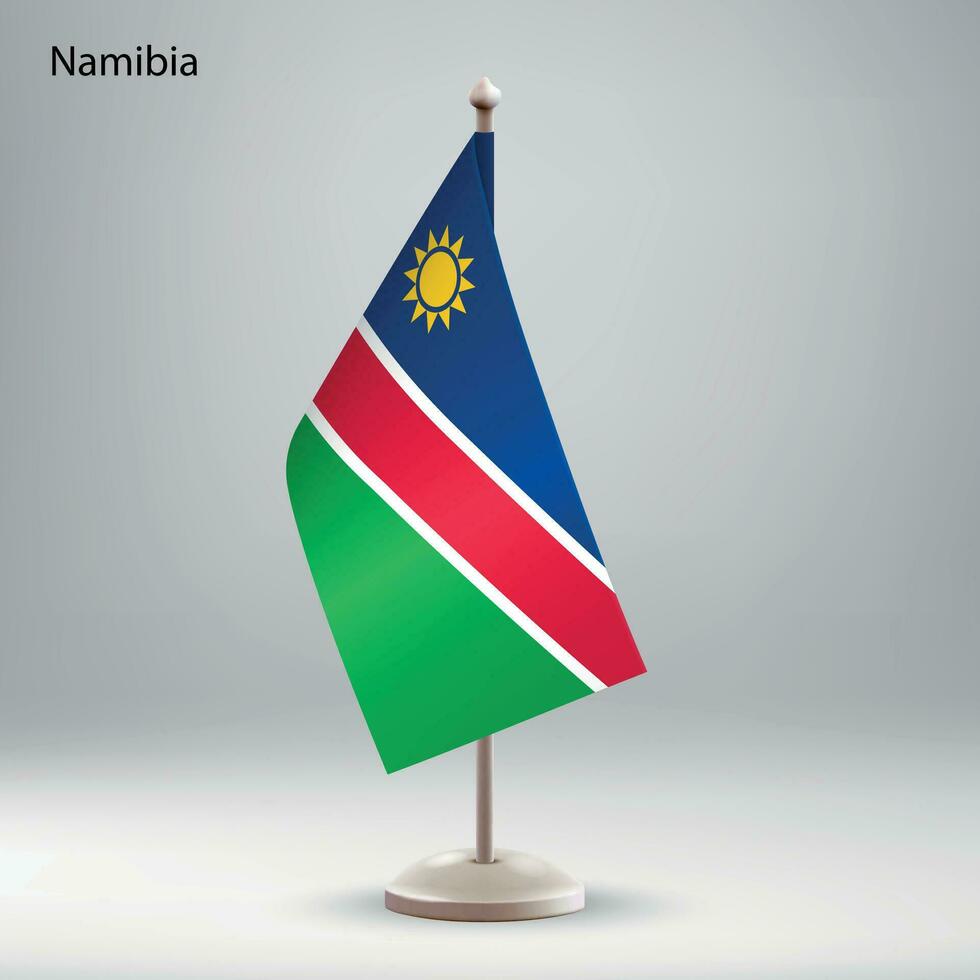 Flag of Namibia hanging on a flag stand. vector