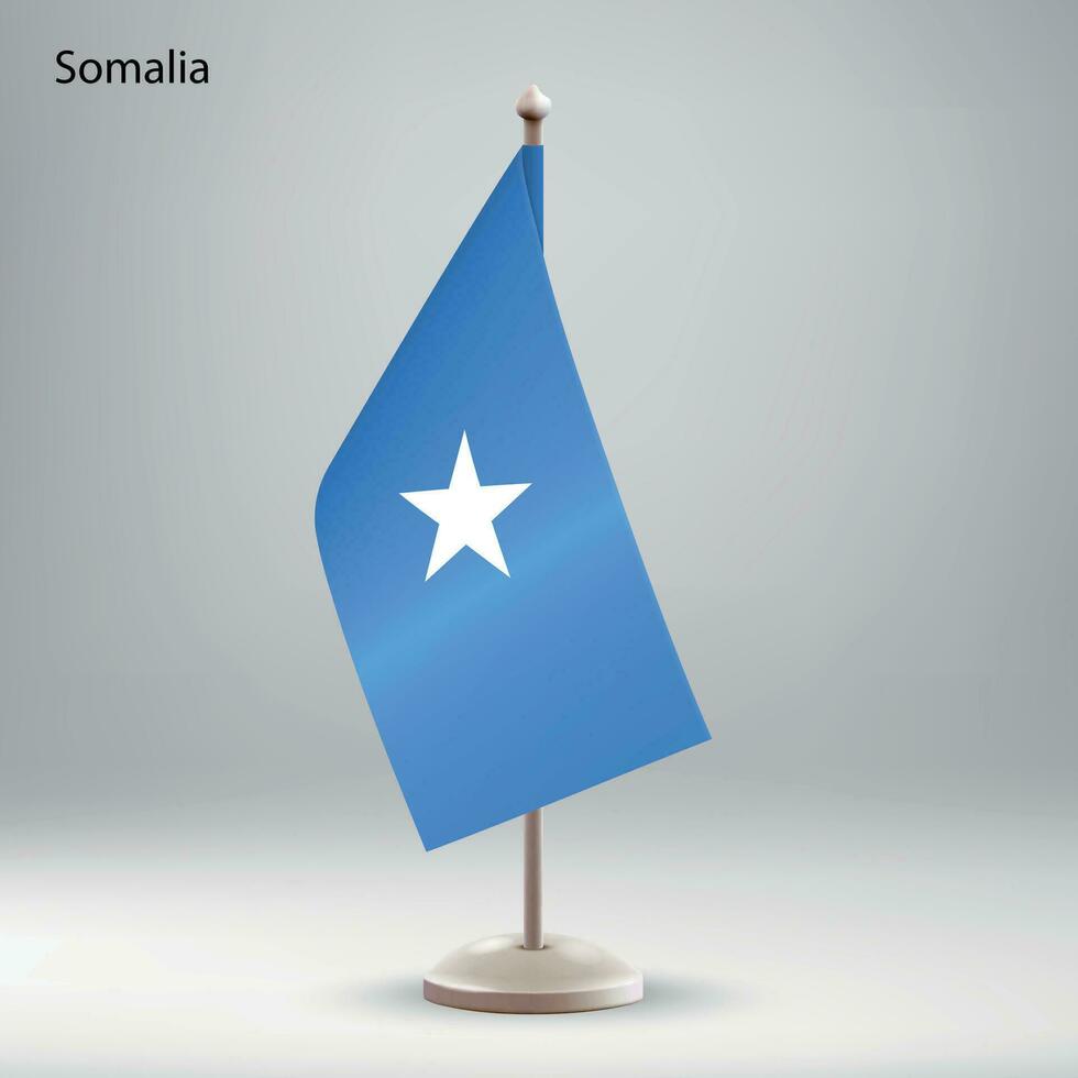 Flag of Somalia hanging on a flag stand. vector