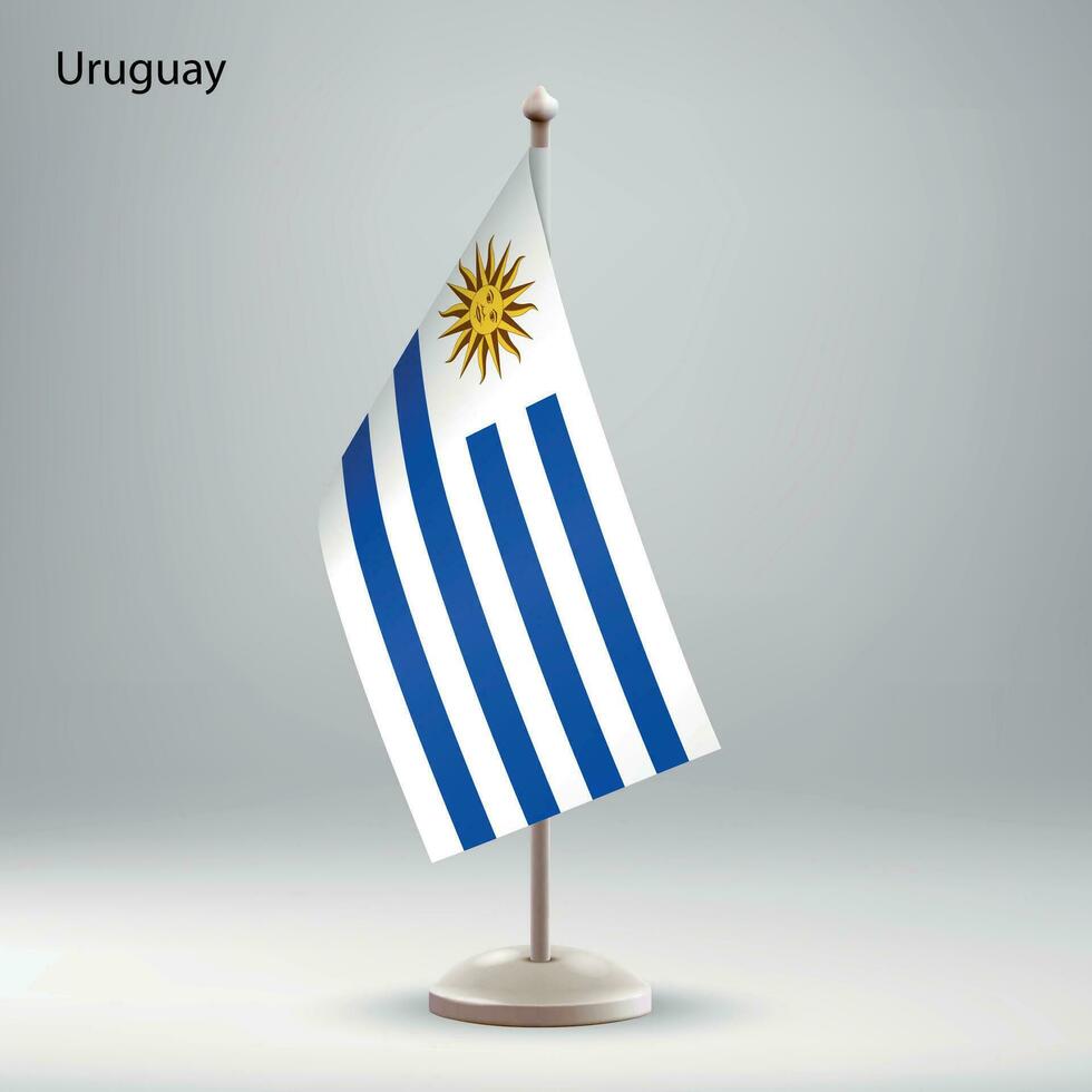 bandera de Uruguay colgando en un bandera pararse. vector