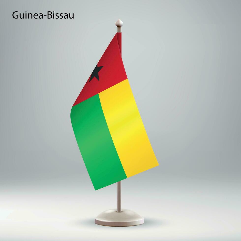 Flag of Guinea-Bissau hanging on a flag stand. vector