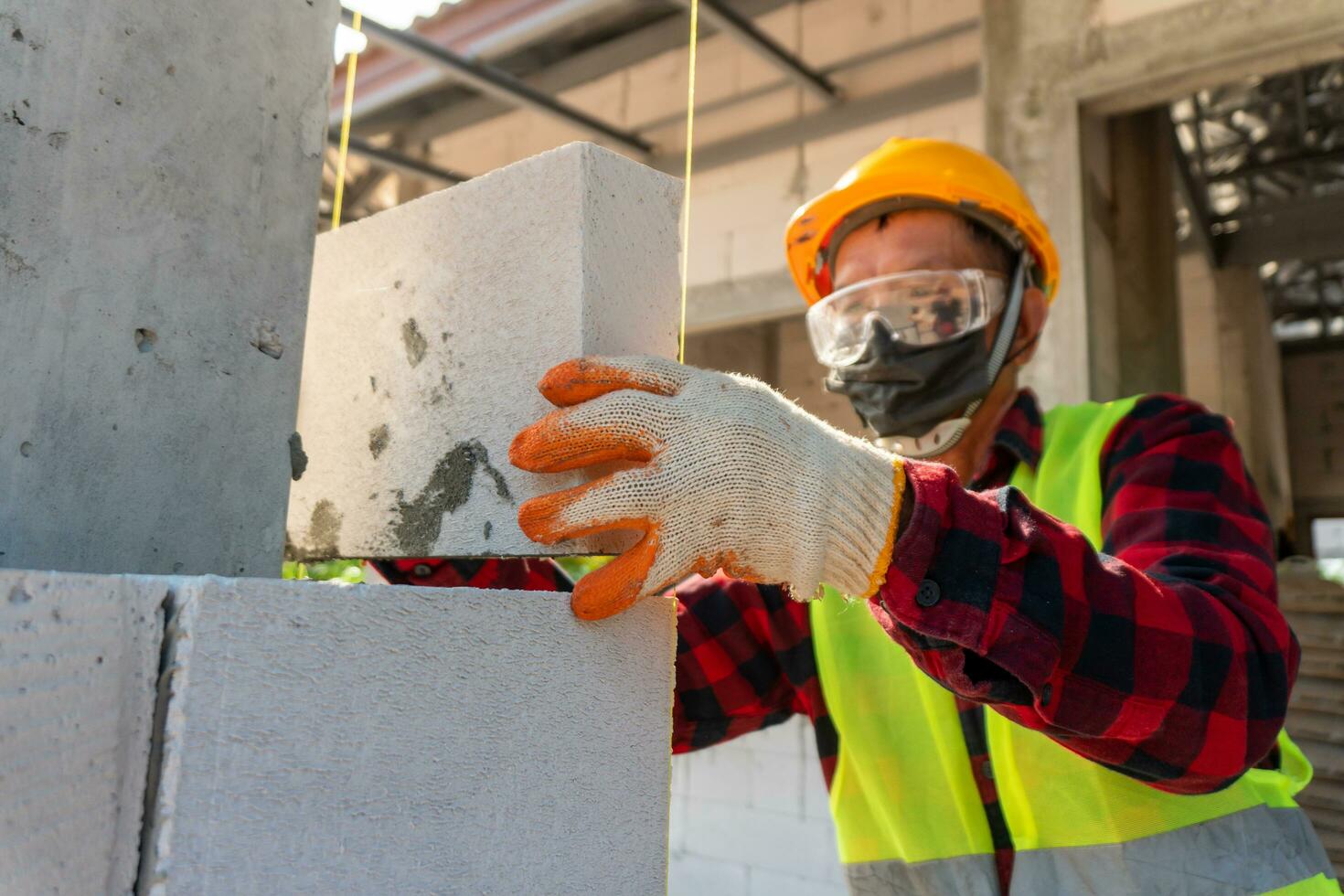 Lightweight brickwork workers on home construction site photo