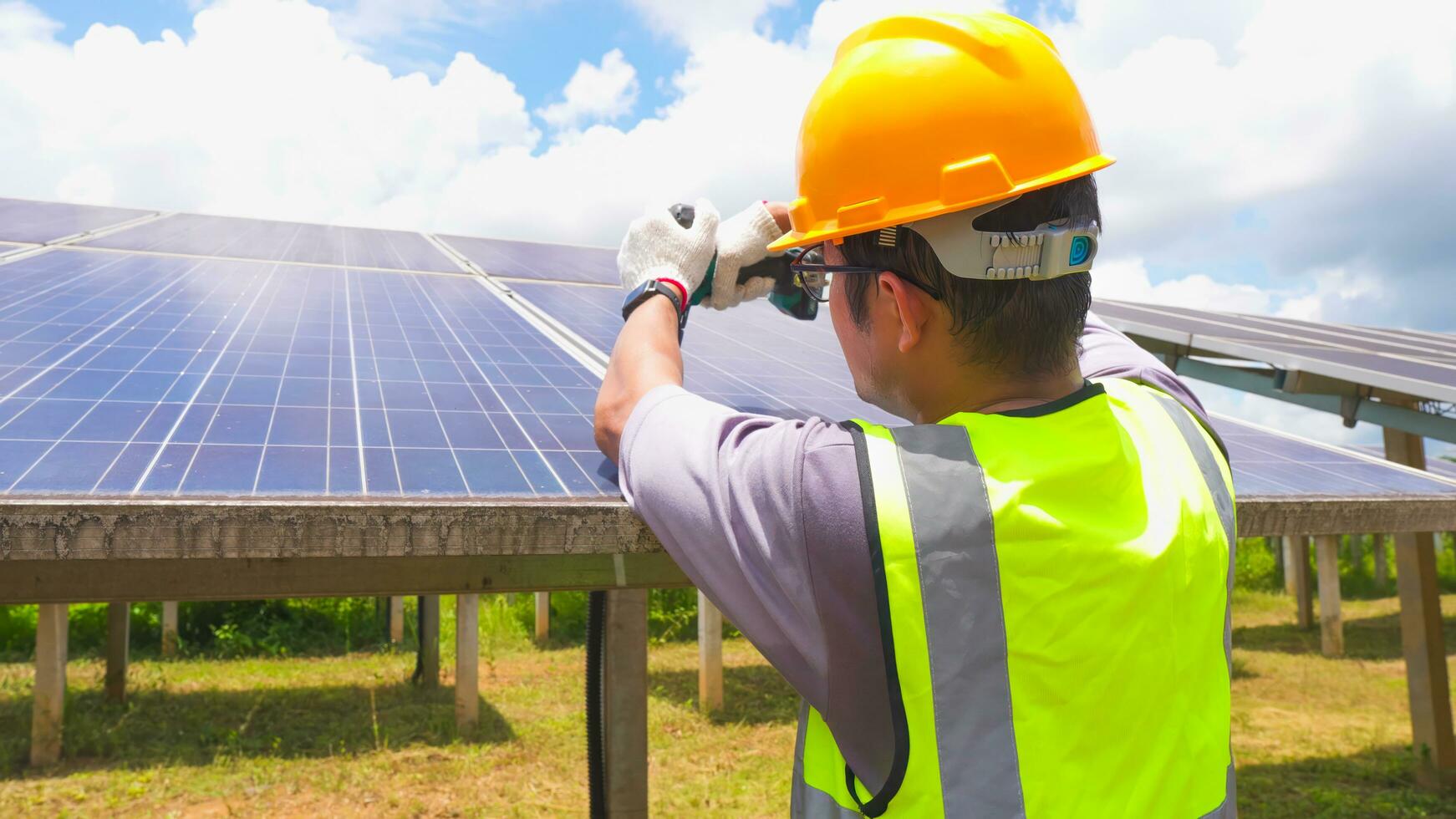 Two asian engineers installing solar panels . Solar energy clean and green alternative energy. Unity and teamwork. photo