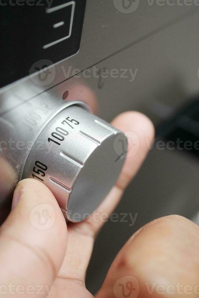 setting temperature control on oven. photo