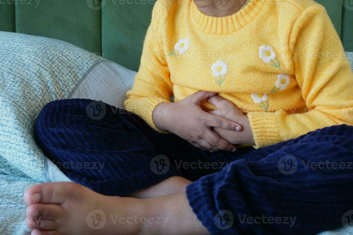 child suffering stomach pain close up. photo