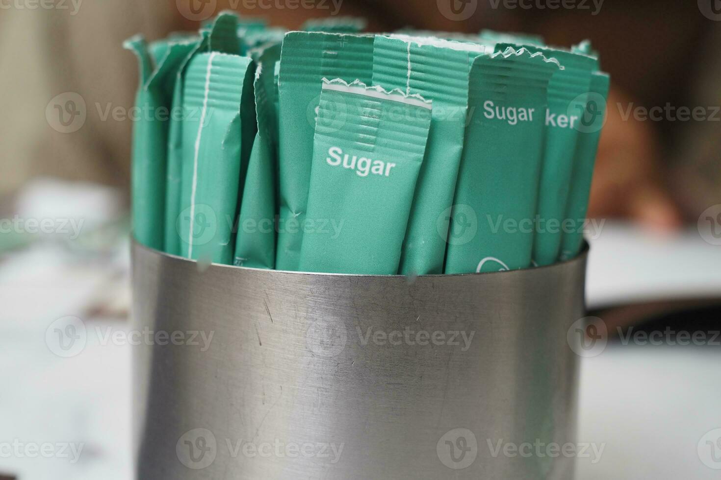 white sugar in a paper packet on table photo