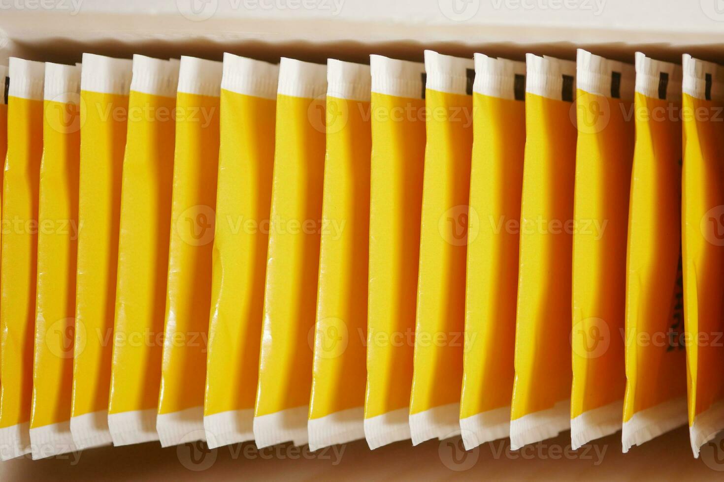 tea bags in yellow packet on table photo