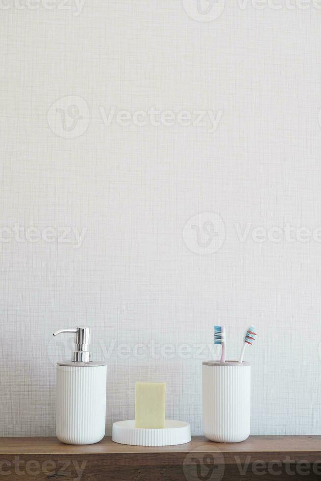 bathroom soap dispenser and toothbrush cup photo