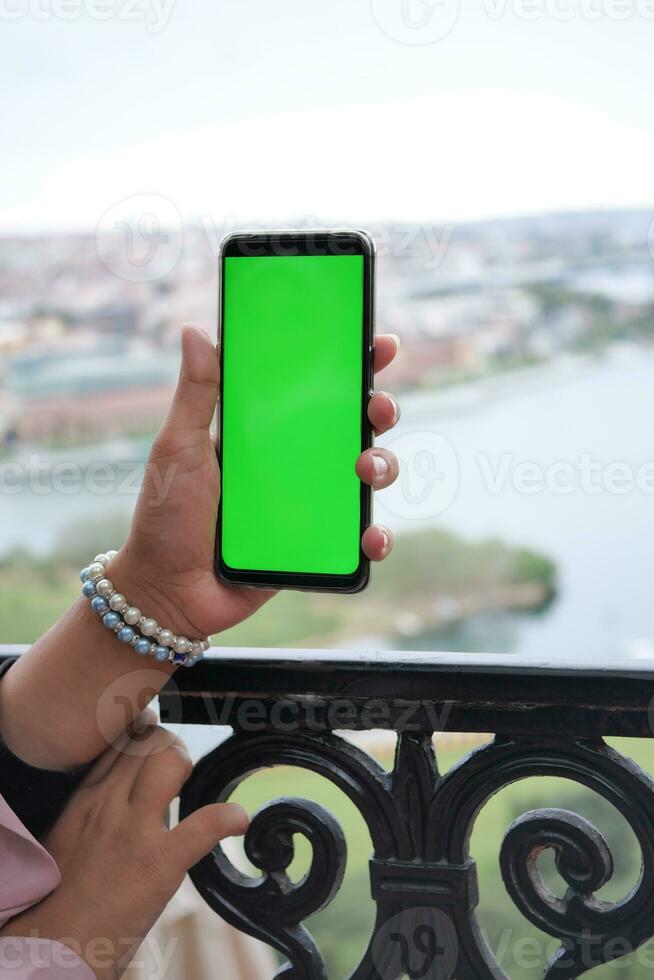 rear view of young man using smart phone at outdoor photo