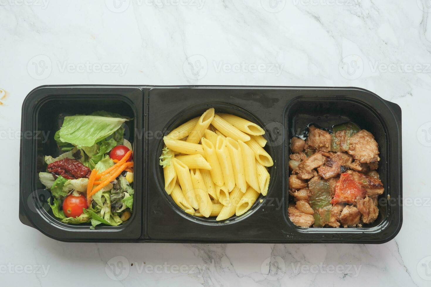 pasta, chicken and herbs in a plastic container photo