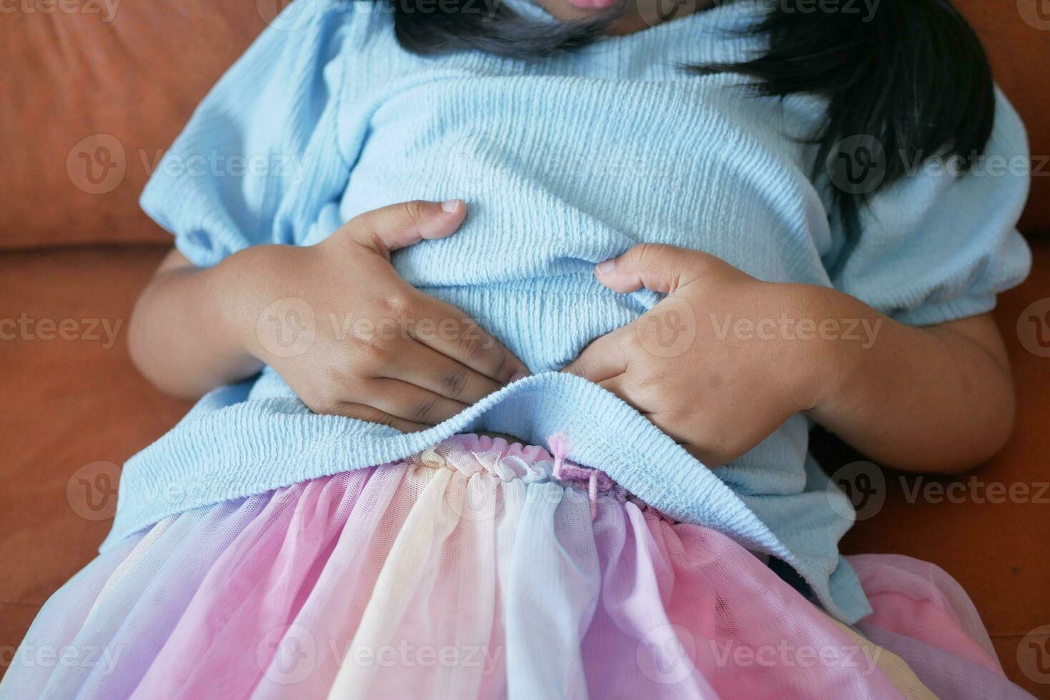 child suffering stomach pain close up. photo