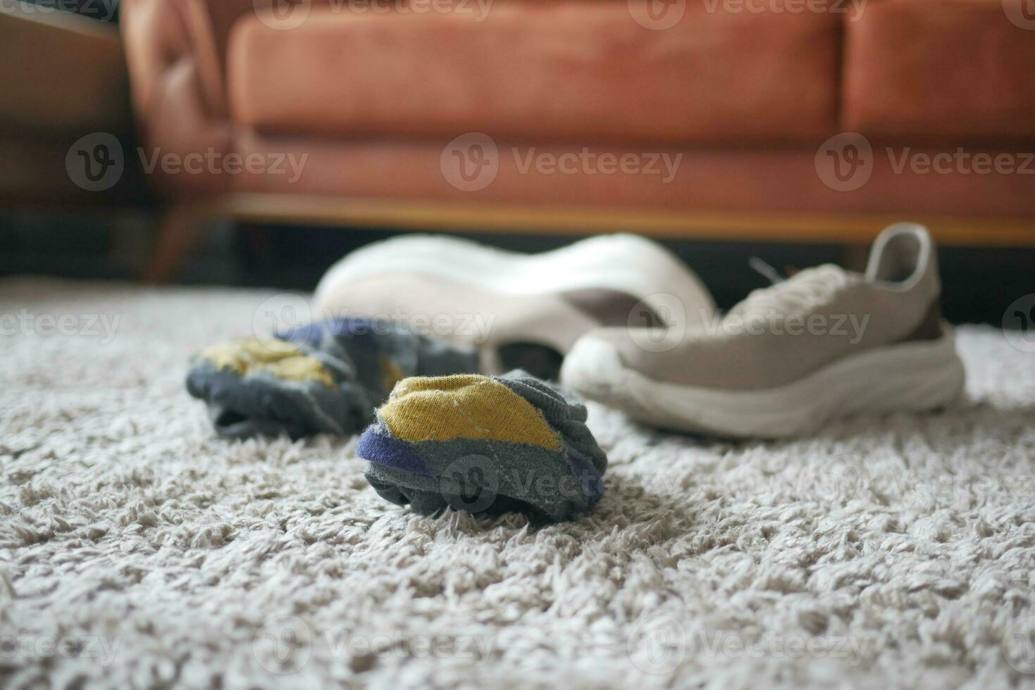 dirty sock and shoe on floor photo