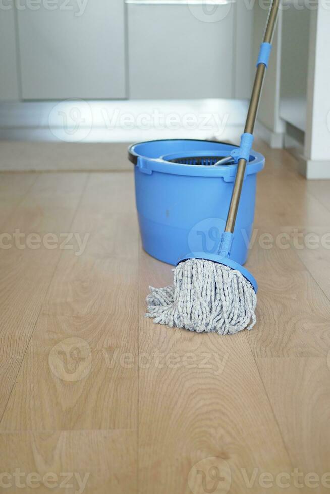 cleaning tiles floor with mop photo