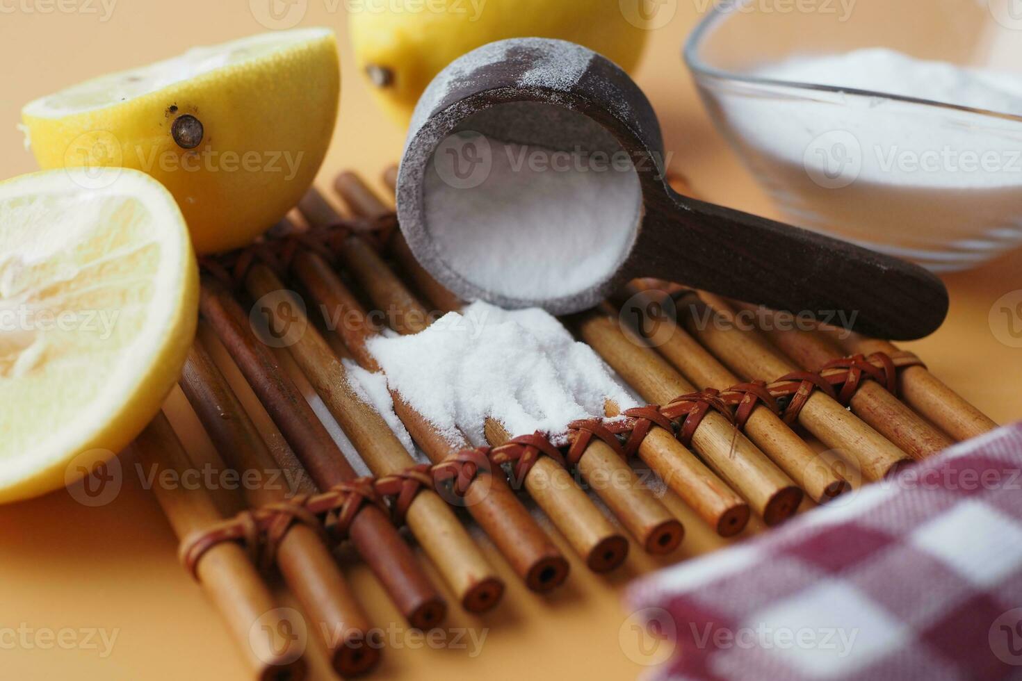 Baking soda and whole lemon on table photo