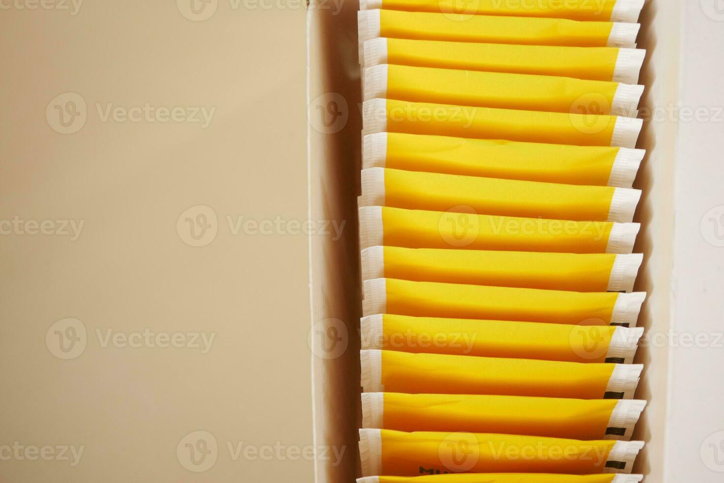 yellow color tea bags packet in a box photo