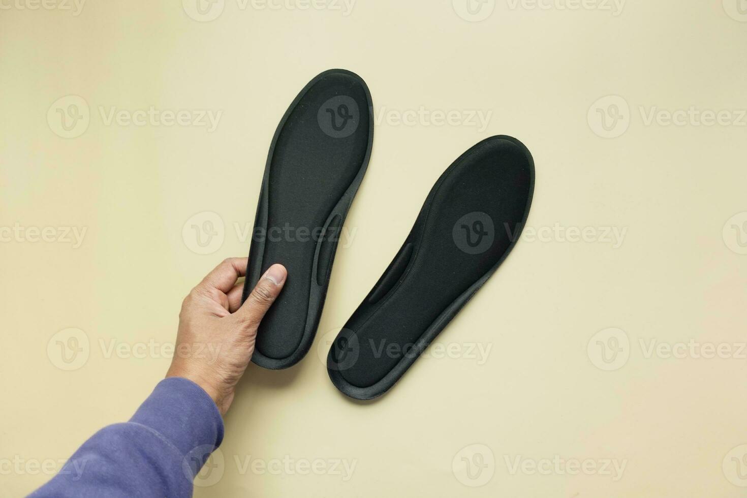 men hand holding a Orthopedic insole photo