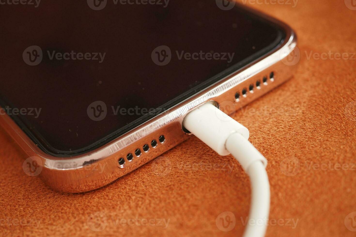 charging smart phone with a cable photo