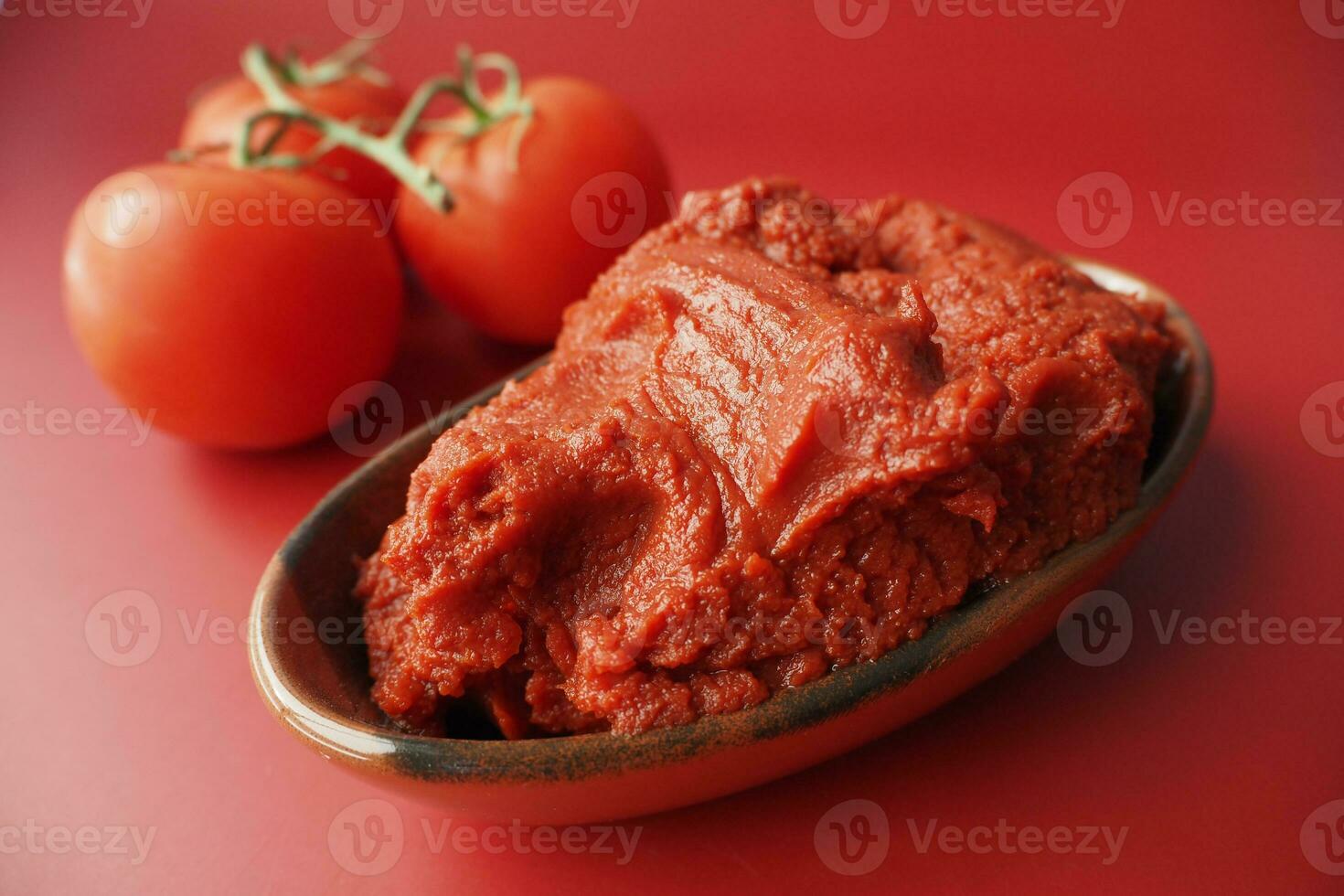 Tomato paste with ripe tomatoes. photo