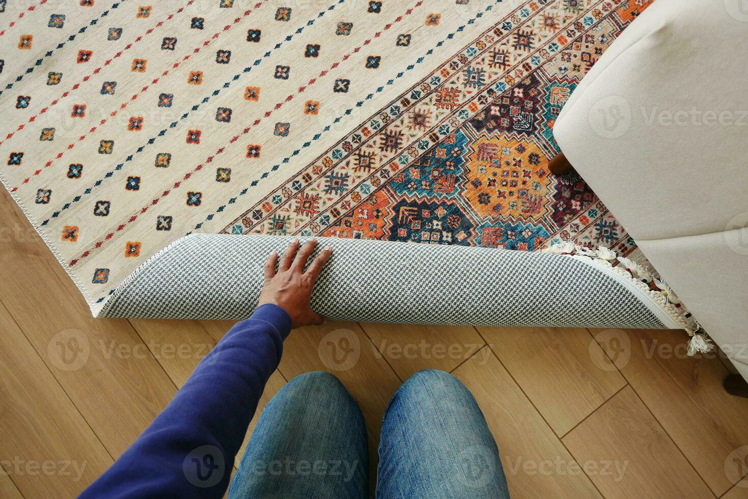 top view of men rolling out new rug. photo