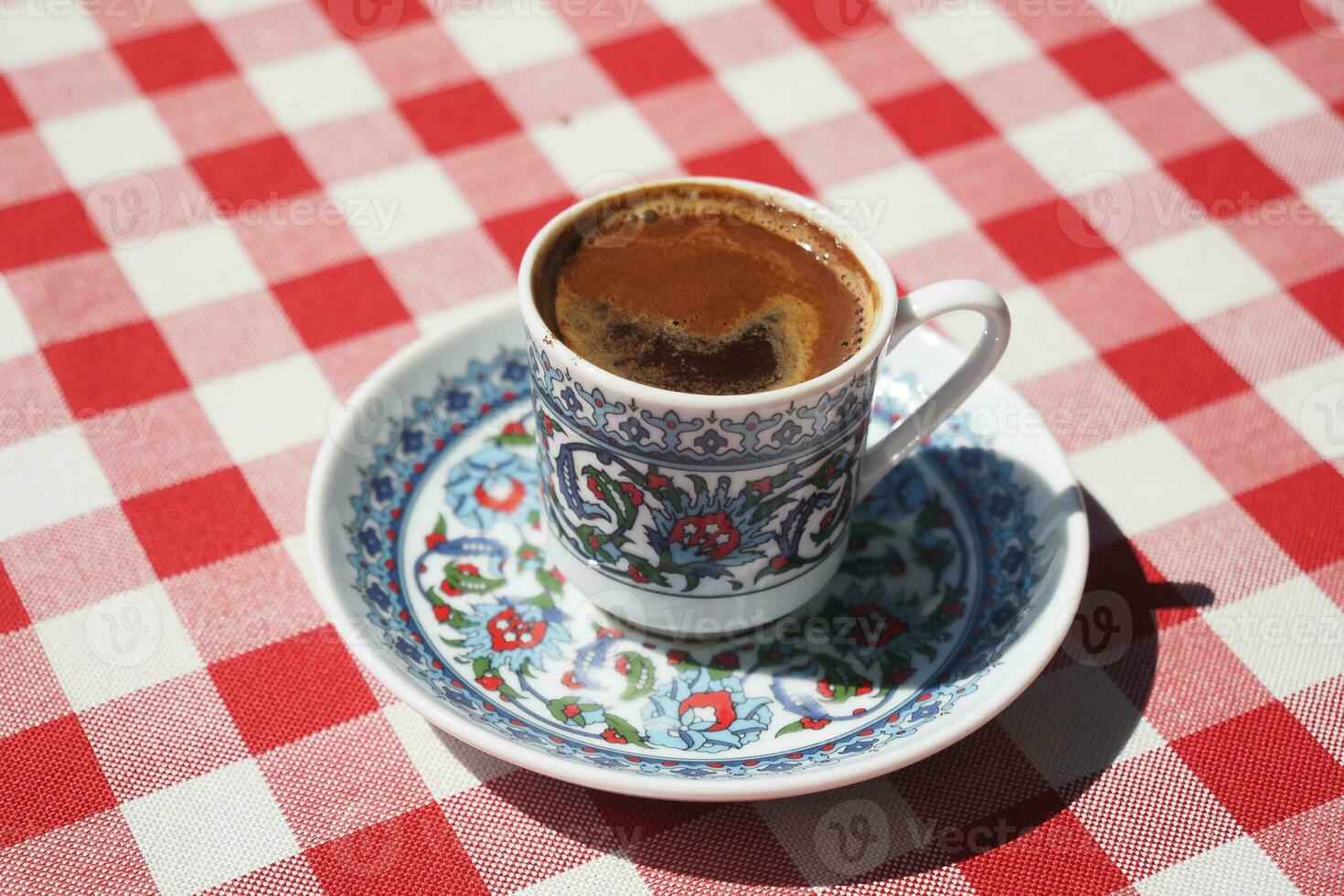 a cup of turkish coffee on table photo