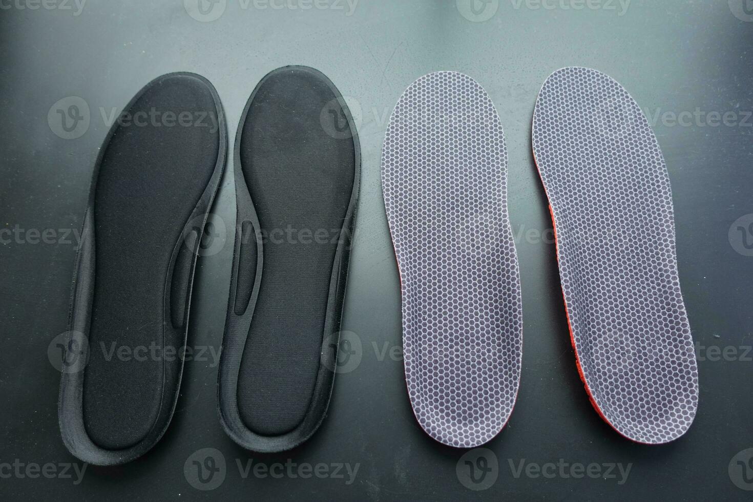 Closeup of Orthopedic insoles in shoes on black background photo