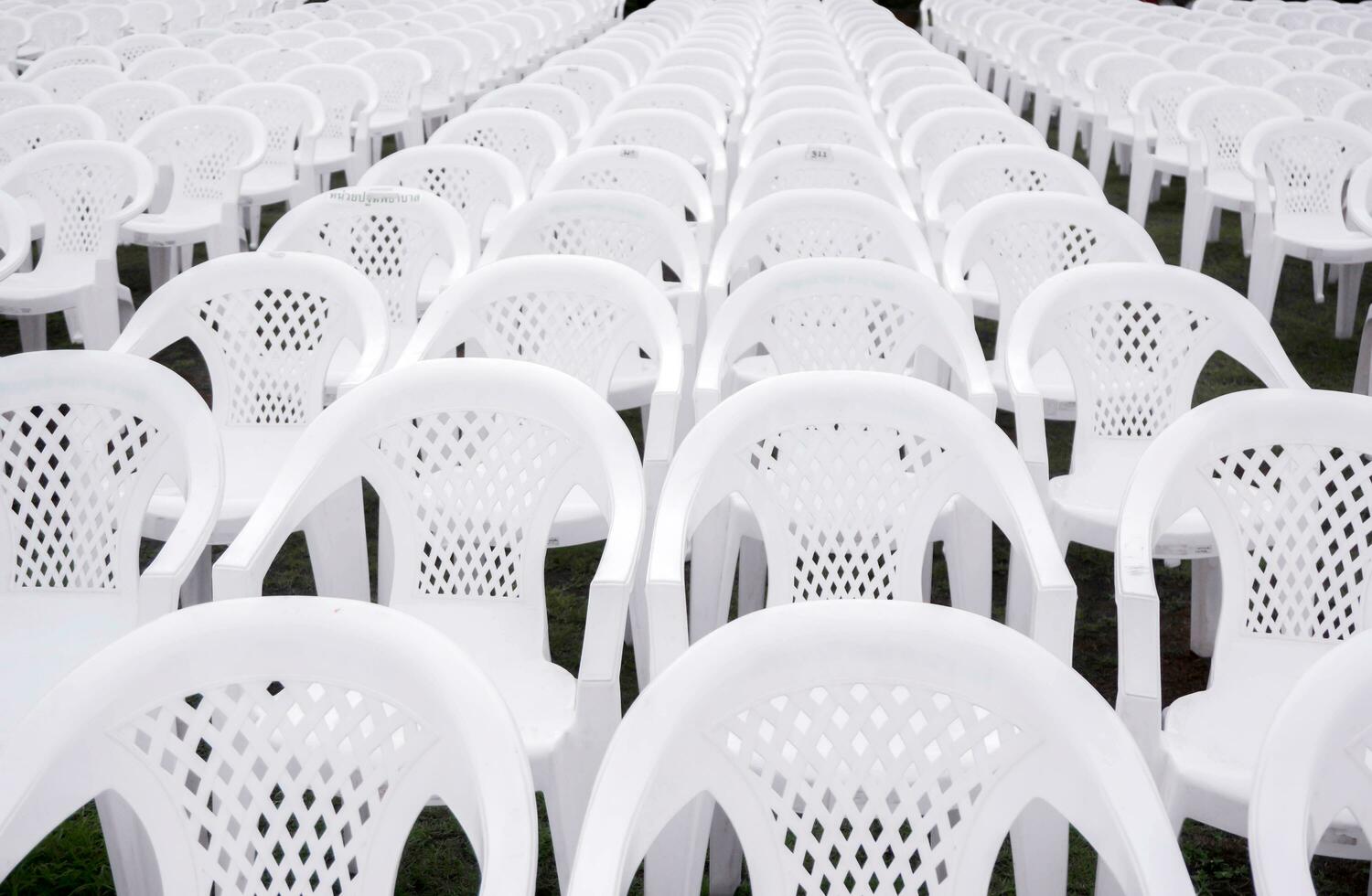 Closeup and crop white plastic chairs put on lined in rows for students in the graduation ceremony. photo