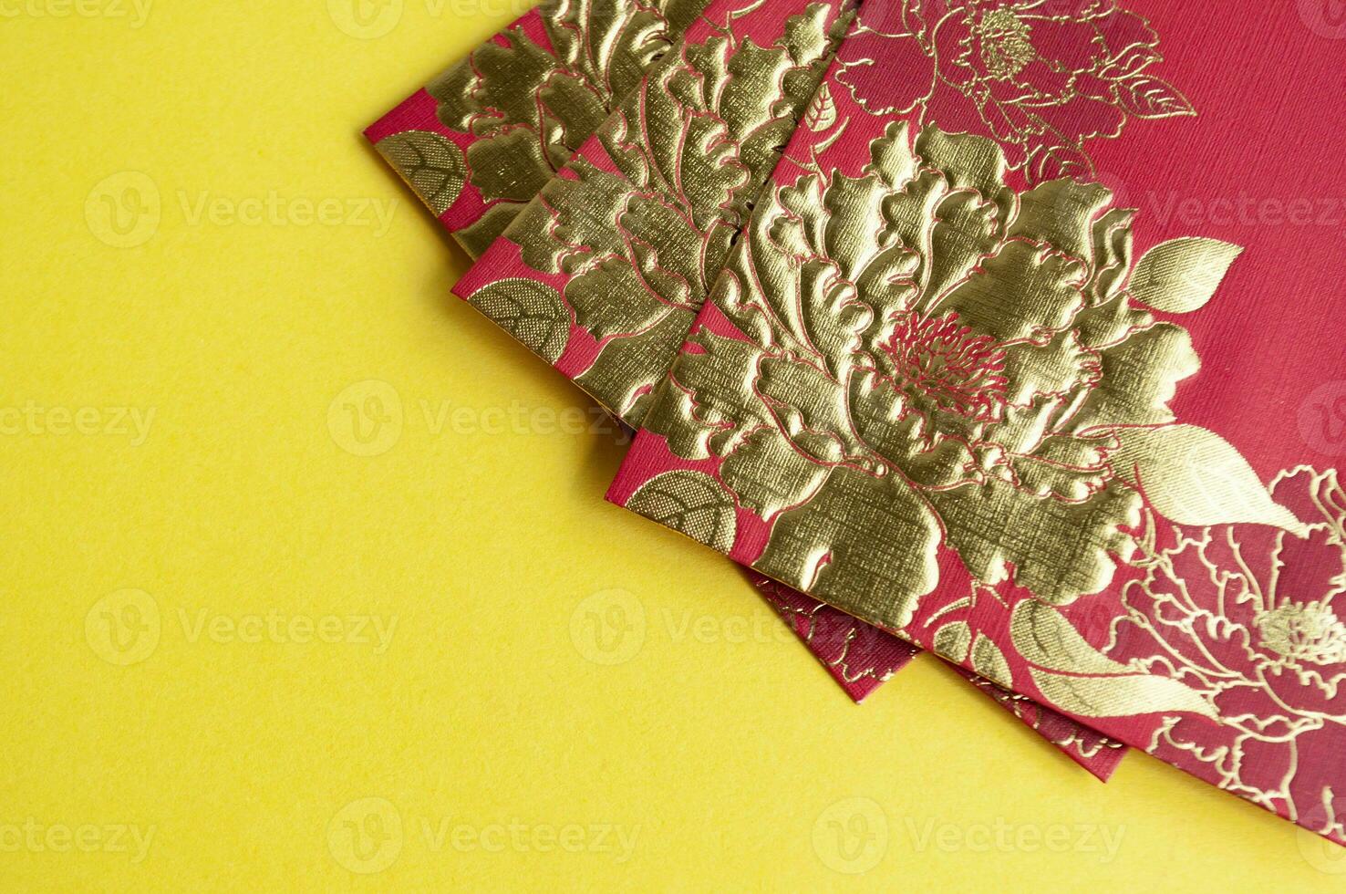 Chinese New Year red packets on yellow cover background with customizable space for text photo