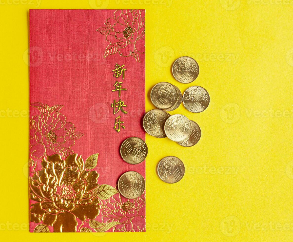 Top view of Chinese New Year red packets on yellow cover background. Customizable space for text photo