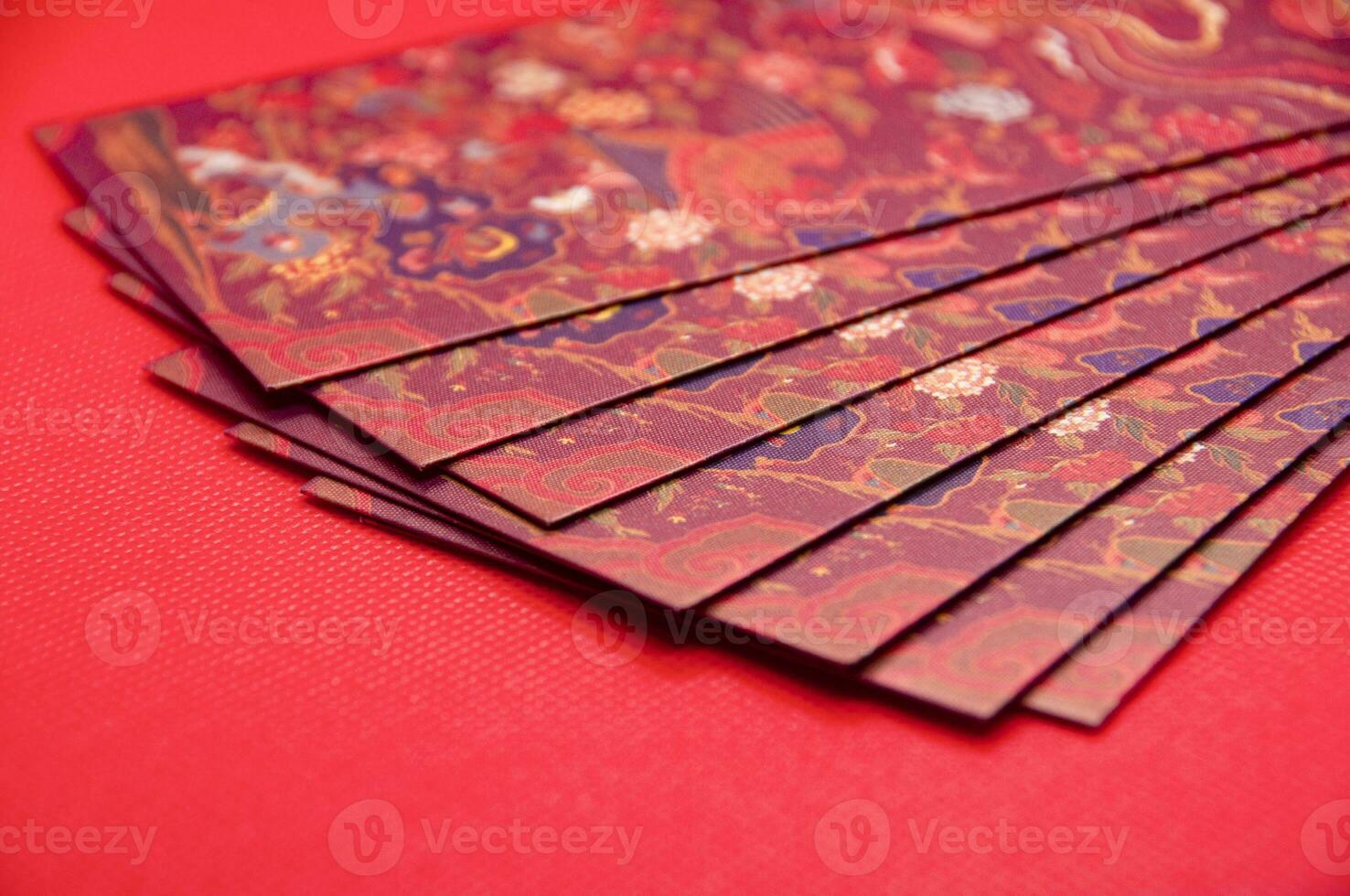 Close up of Chinese New Year red packets on red cover background with customizable space for text photo