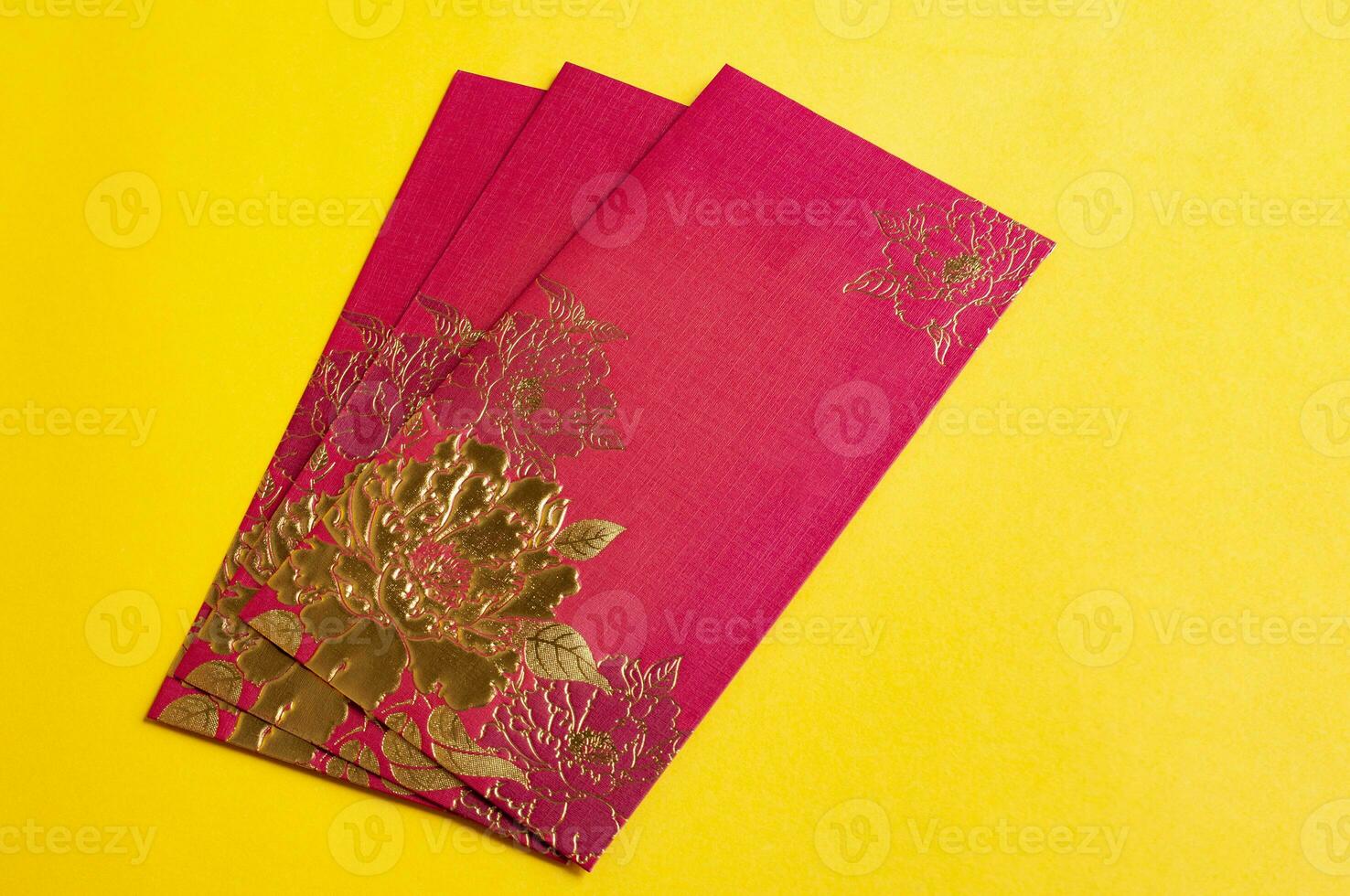 Chinese New Year red packets on yellow cover background with customizable space for text photo