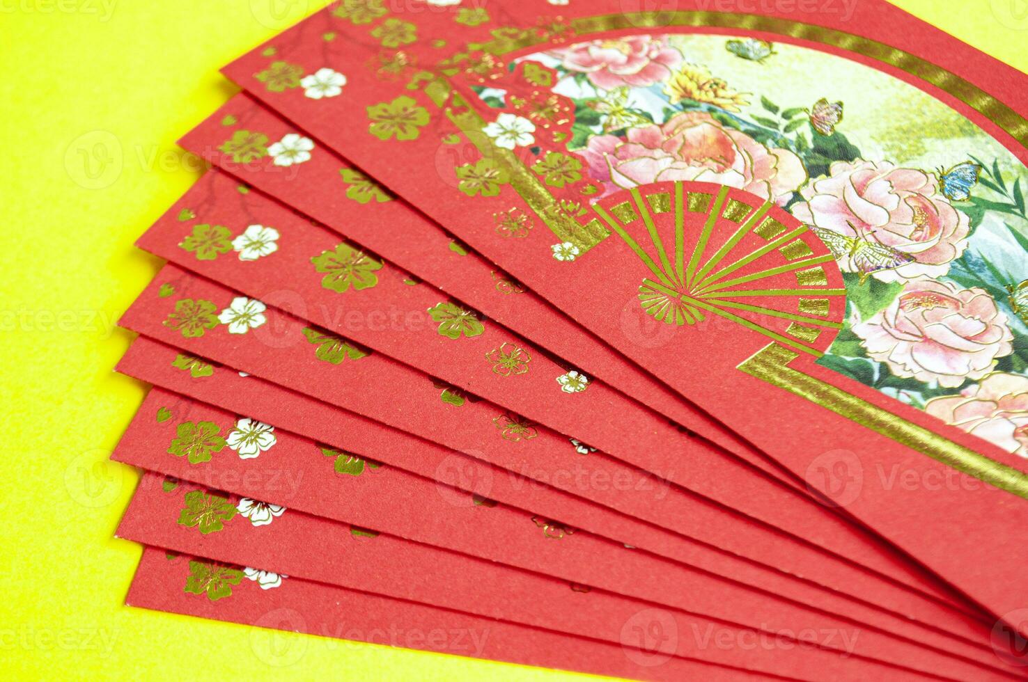 Chinese New Year red packets on yellow cover background with customizable space for text photo
