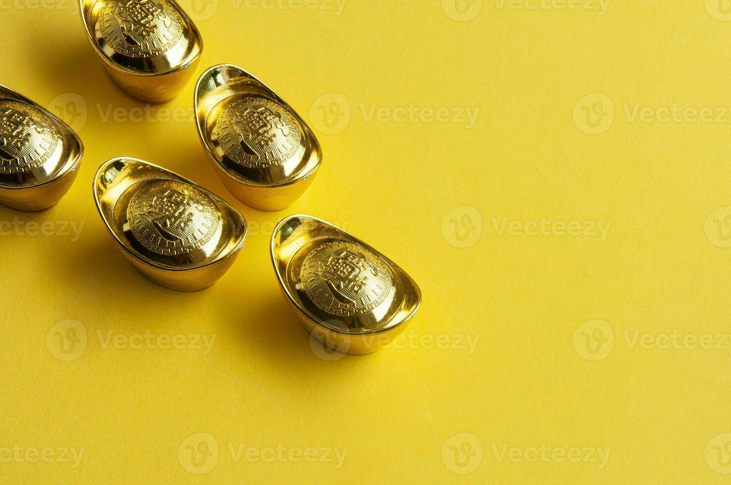 Top view of golden ingot on yellow cover background photo