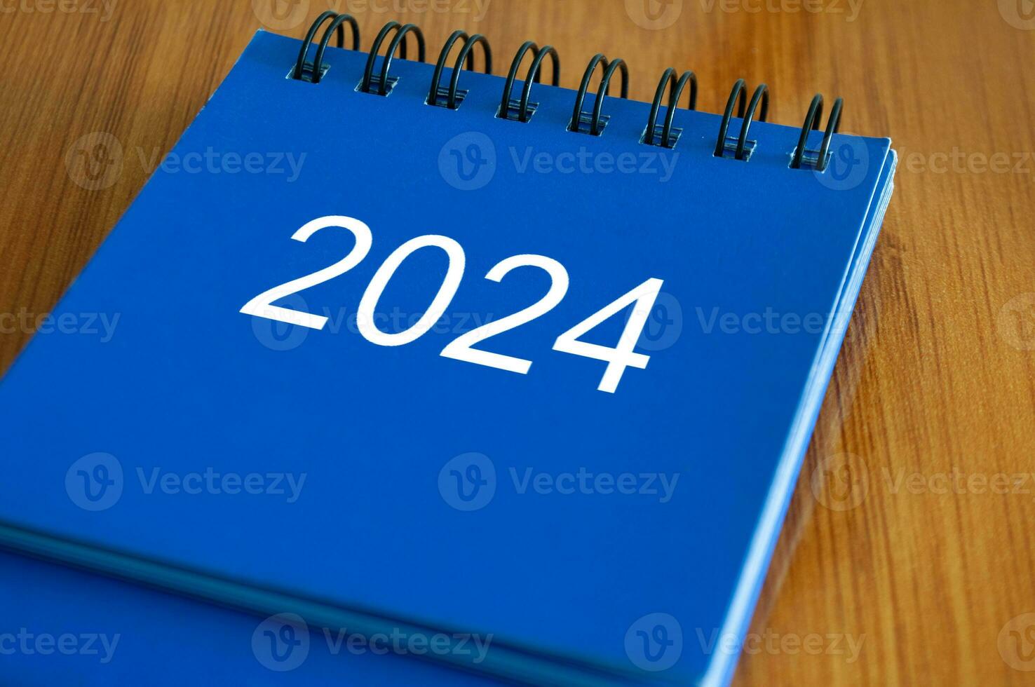 2024 table calendar on wooden desk. Time and calendar concept photo