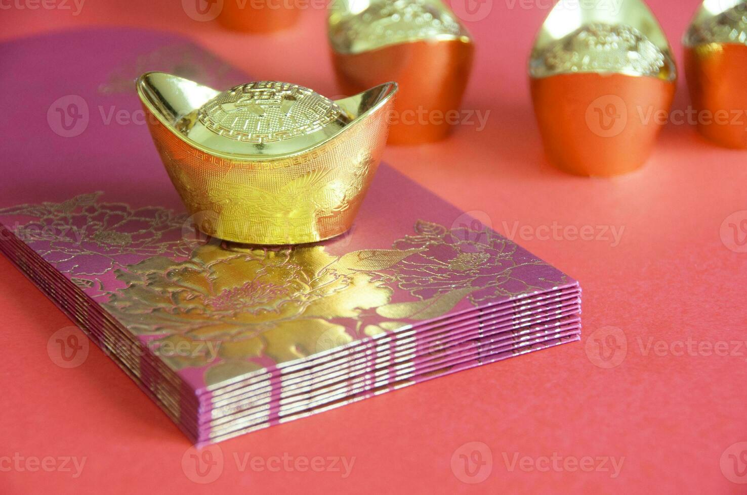 Chinese New Year red packets and golden ingot on yellow cover. Customizable space for text. photo