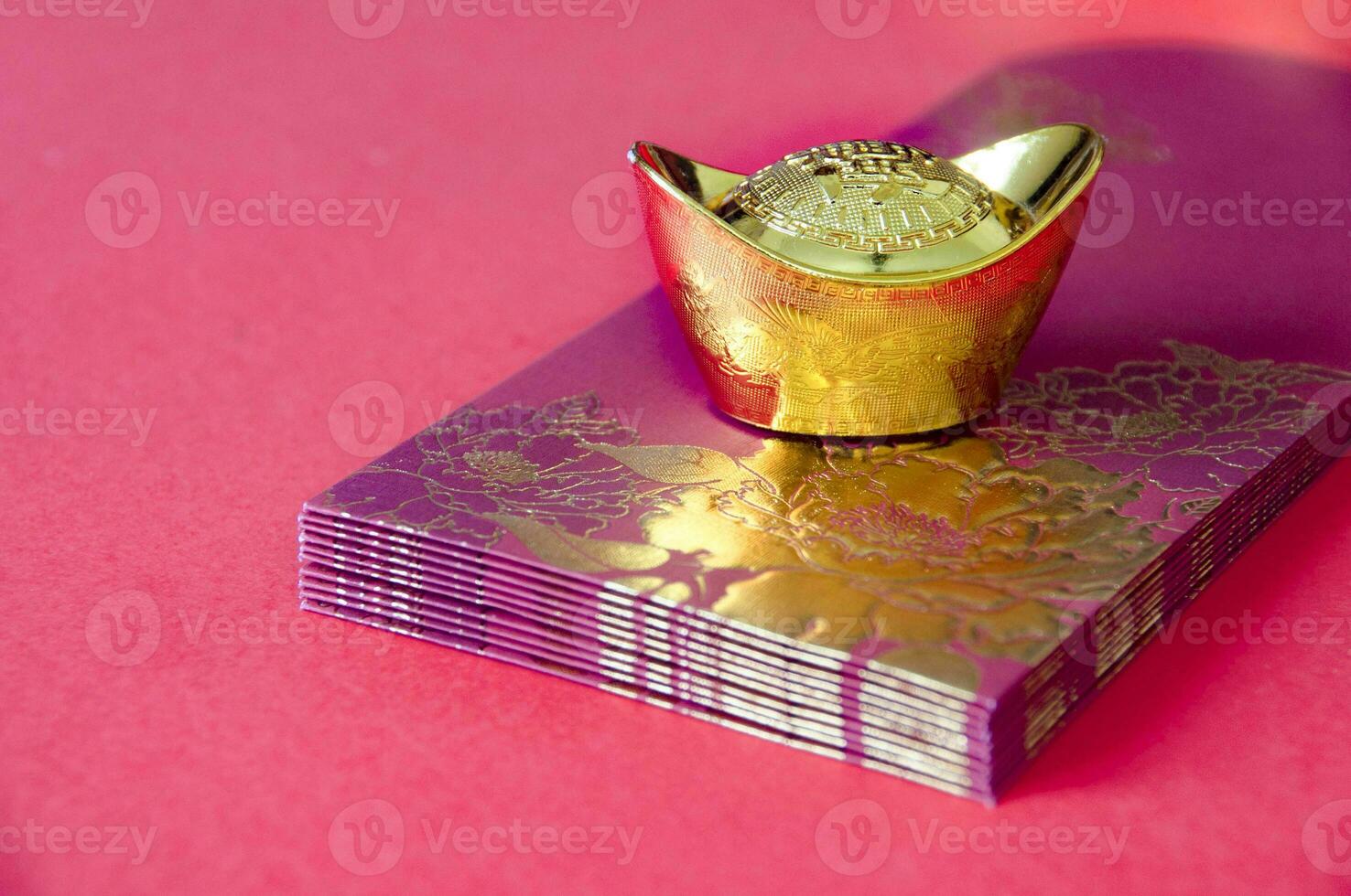 Close up of Gold ingot on top of Chinese New Year packets. Chinese new year decoration concept photo