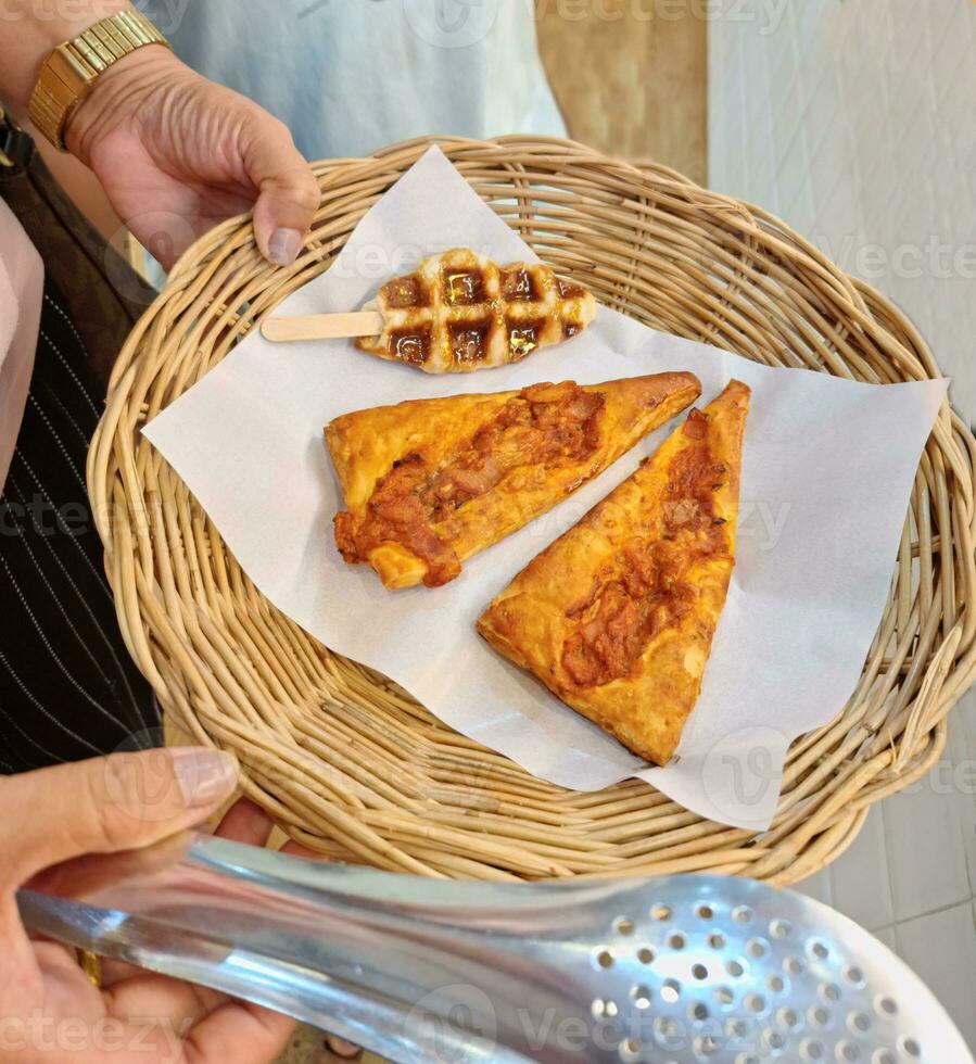 Image of a hand holding bread in a basket photo