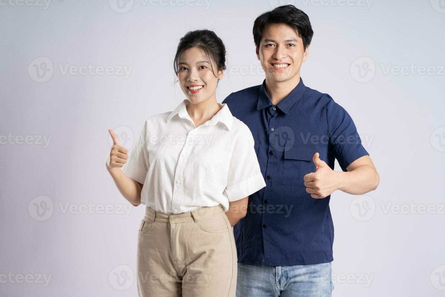 Image of an Asian couple posing on a white background photo